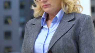 Yaşlı kadın ofis çalışanı gelecekteki emeklilik, düşük maaş üzerinde düşünme