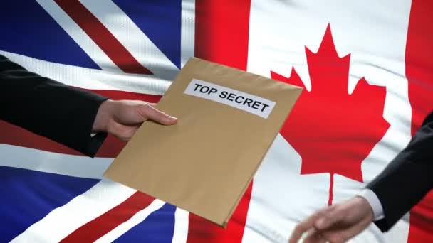 Great Britain and Canada politicians exchanging top secret envelopes, flags — Stock Video