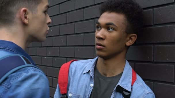 Adolescente assediando o cara afro-americano no pátio da escola, desrespeito aos direitos humanos — Vídeo de Stock