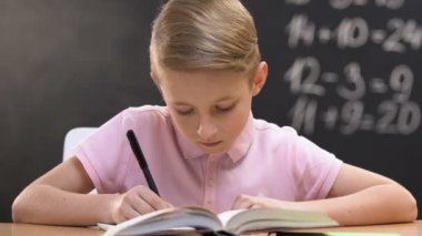 Studious öğrenci yazma test çalışması, okul dersleri, kara tahta üzerinde matematik denklemi