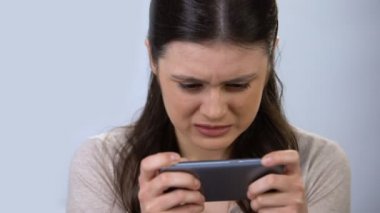 Gadget bağımlısı kadın akıllı telefon, modern teknoloji üzerinde video oyunu oynuyor