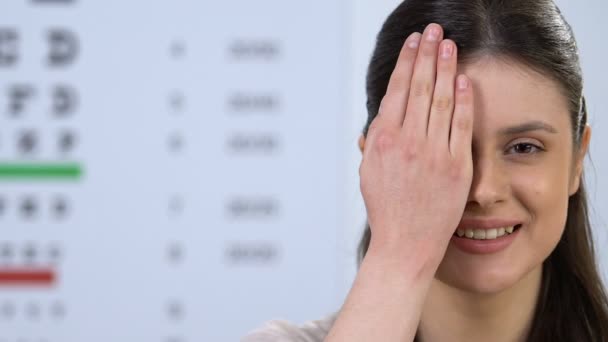 Smiling woman closing eye with hand, healthy vision, doctor examination — Stock Video