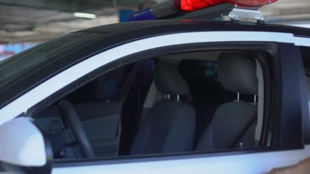 Police mates getting into patrol car ready to drive to crime scene, public order — Stock Video