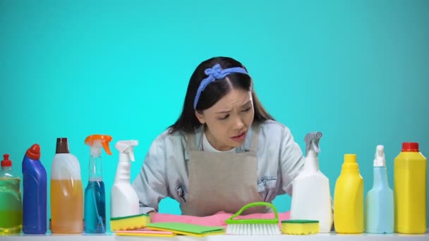 Sad housewife in gloves looking at detergents and crying, cleaning service need — Stock Video