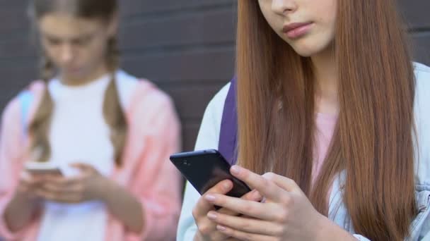 Adolescentes utilizando teléfonos celulares, ignorando la comunicación en vivo, adicción a los gadgets — Vídeos de Stock