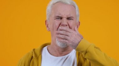 Parlak arka plan closeup üzerinde esneme olgun adam, vitamin eksikliği, yorgunluk