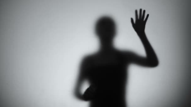 Silhouette einer verzweifelten Frau, die hinter Glas weint, psychische Störung, hysterisch — Stockvideo
