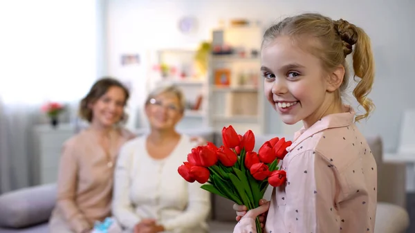 Old Mother Daughter Looking Small Girl Giving Tulips Smiling Camera — Stock Photo, Image