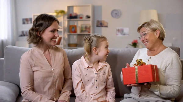 Surprised Grandmother Holding Gift Box Daughter Granddaughter Holiday — Stock Photo, Image