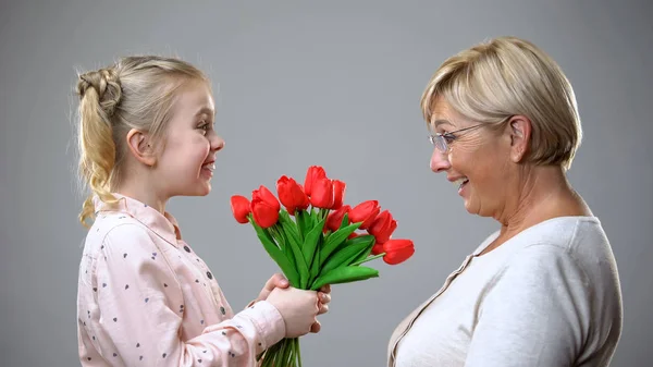 Happy Girl Giving Flowers Grandmother Family Tradition Holiday Celebration — Stock Photo, Image