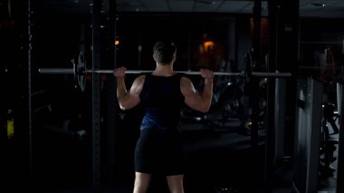 Halter ile egzersiz yaparak vücut geliştirmeci kol ve omuz kasları eğitim