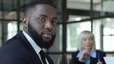 Afro-Amerikan erkek çalışan kamera, işyerinde ırksal eşitlik bakıyor