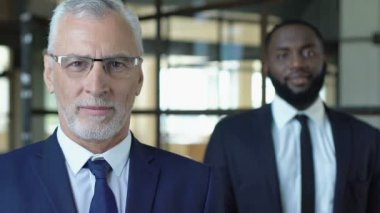 Zengin çok ırklı işadamları fotoğraf makinesi, başarılı şirket kurucuları poz