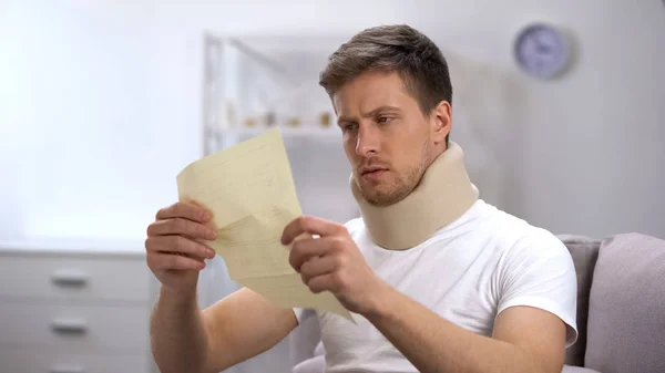 Man Foam Cervical Collar Reading Medical Bill Shocked High Price — Stock Photo, Image