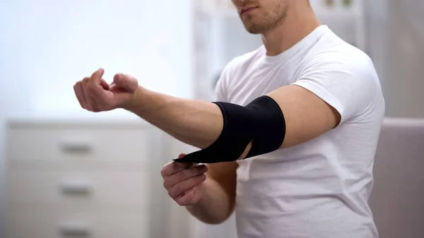 Young Male Applying Elbow Padded Orthosis Orthopedics Physiotherapy Health — Stock Photo, Image