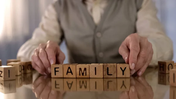 Aposentado Masculino Fazendo Palavra Família Cubos Madeira Mesa Solidão Velhice — Fotografia de Stock