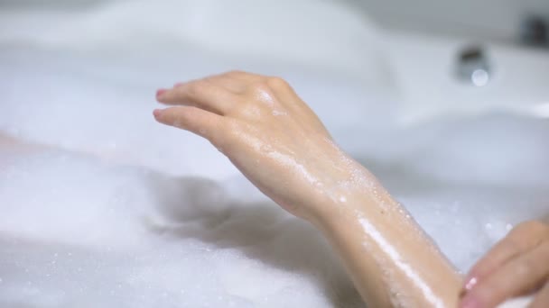Female in bath with foam bubbles washing hand with soap, skin care, close-up — Stock Video