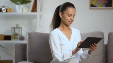 Gülümseyen kadın evde tablet Pc kaydırma, uçak bileti, teknoloji rezervasyon