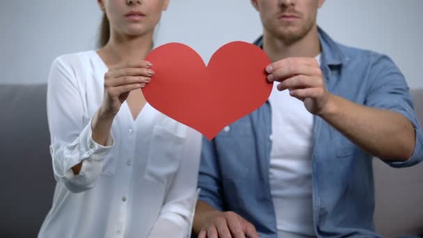 Jovem família rasgando em pedaços de papel ouvido, conceito de problema de relacionamento — Vídeo de Stock