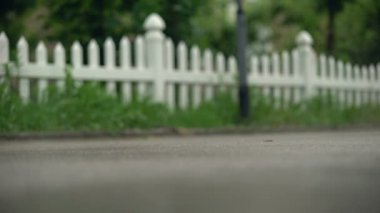 Çocuk yağmurdan sonra hızlı koşuyor, sisiçinde kaldırım, ayakları yakın, eve acele