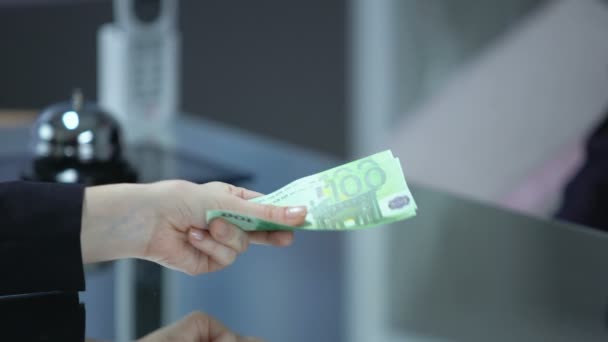 Бизнес-леди, дающая регистратору отеля банкноты евро, оплачивающая услуги, vip — стоковое видео