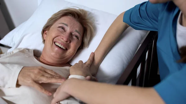 Caring Nurse Telling Jokes Old Female Patient Lying Sickbed Rehabilitation — Stock Photo, Image