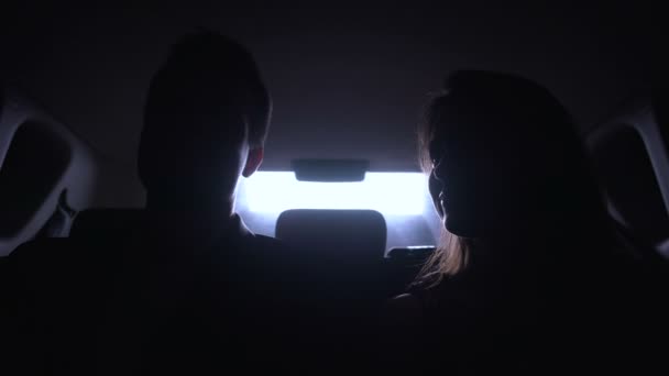 Young man and woman talking in automobile, driving to evening party, stars life — Stock Video