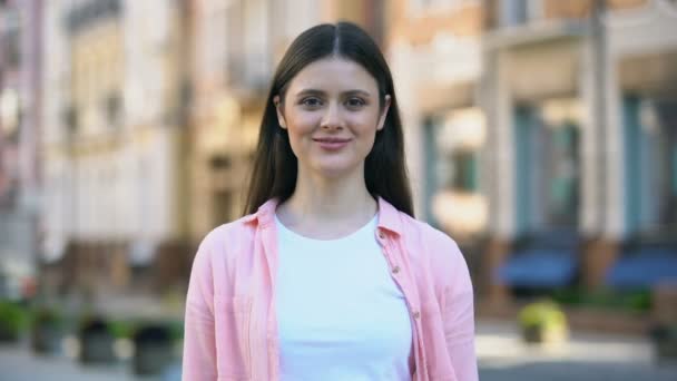 Smiling woman on street making camera frame gesture with hands, photo focusing — Stock Video