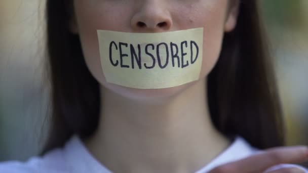 Woman taking off tape with censored word over mouth, democracy concept, freedom — Stock Video