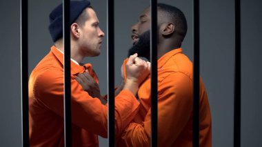 Black and caucasian prisoners having fight in cell, jail overcrowding, conflict clipart