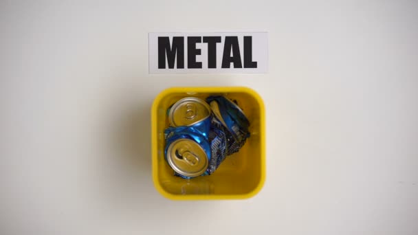 Metal word written near container with cans, collecting reusable garbage recycle — Stock Video