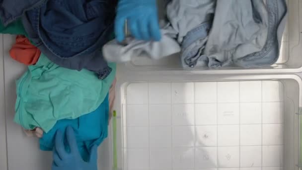 Volunteer hands dividing denim and textile clothing on waste sorting line, reuse — Stock Video