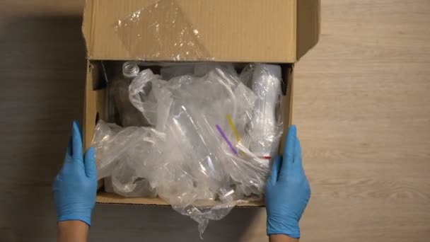 Drop-off station worker in gloves checking plastic trash in box, reduce waste — Stock Video