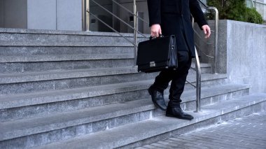 Elegant male in suit with briefcase walking downstairs office building, business clipart