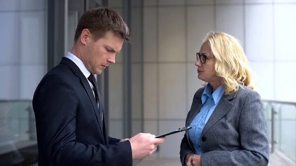 Aged Irritated Business Lady Looking Young Office Colleague Holding Document — Stock Photo, Image