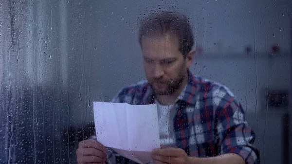 Sad Man Reading Letter Rainy Window Bank Credit Payment Overdue — Stock Photo, Image