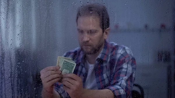 Man Van Middelbare Leeftijd Tellen Geld Achter Regenachtig Venster Slecht — Stockfoto