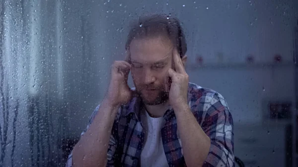 Depressed Man Massaging Temples Rainy Window Suffering Headache — Stock Photo, Image