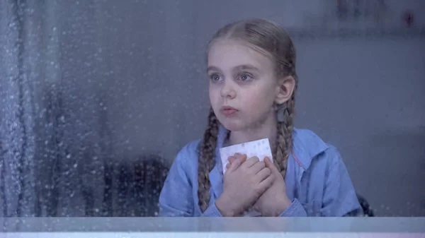 Little Girl Holding Photo Rainy Window Orphan Child Missing Parents — Stock Photo, Image