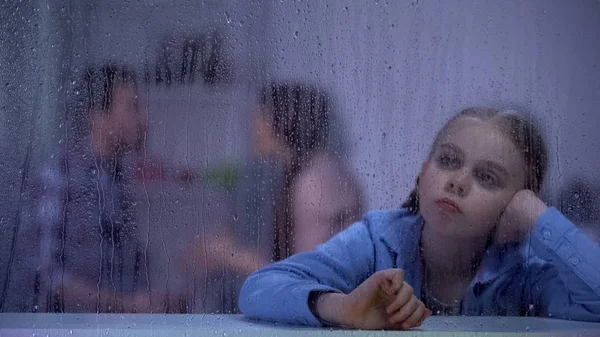 Depressed Girl Sitting Rainy Window Parents Quarrelling Background — Stock Photo, Image