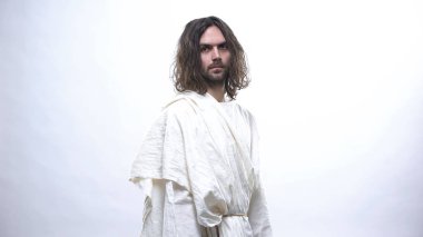 Beyaz cüppeli aziz adam ne yazık ki kameraya bakıyor, insanlık hatalarından rahatsız