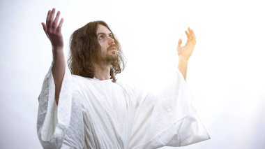 Saint man in robe raising hands to light, praying to God, religious conversion clipart