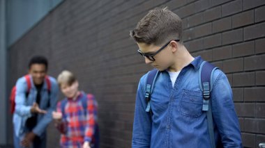 Gençler gözlüklü çocukla alay ediyor, kötü niyetli dedikodular yayıyor, sözlü zorbalık
