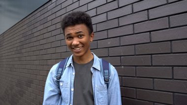 Black boy teasing looking mockingly into camera, emotional bullying in school clipart