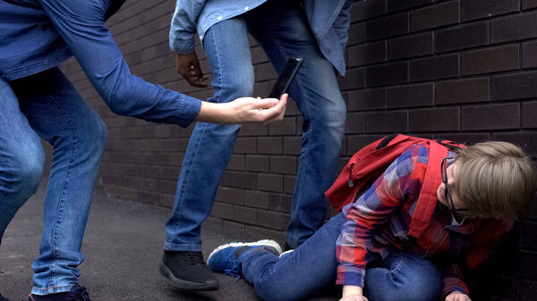 Cruel teenagers mocking boy and making video on smartphone, cyberbullying