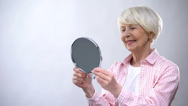 Smiling Aged Woman Looking Mirror Reflection Enjoying Beauty Appearance — Stock Photo, Image