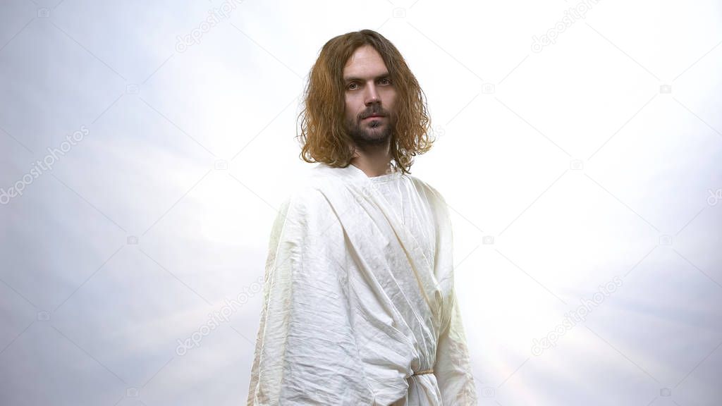 Jesus looking at camera on shiny background, looking with compassion and love
