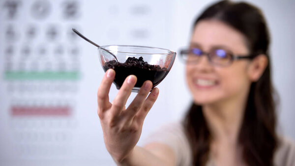 Female patient with blurred vision proposing blueberries, natural treatment