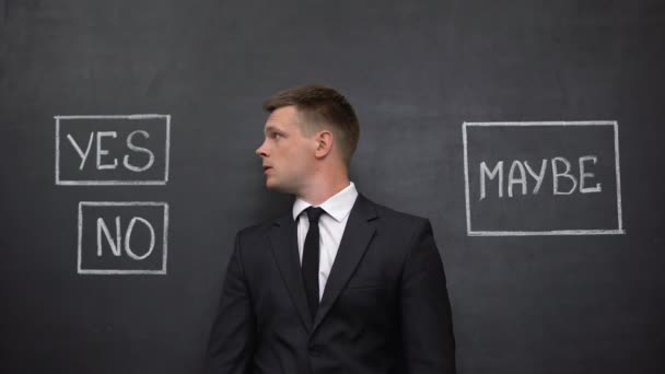 Businessman looking at yes, no and maybe buttons on blackboard, solution search — Stock Video