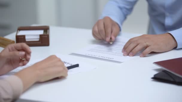 Couple signing divorce policy, woman removing ring, man trying to save relations — Stock Video